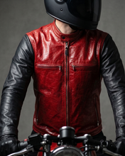 Person wearing a red leather jacket and black helmet on a motorcycle.