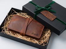 Personalized handmade brown leather tobacco pouch with wraparound strap, presented in a black gift box