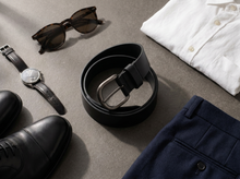 Black leather belt with brushed metal buckle styled with navy trousers and white shirt