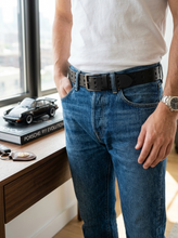 Black perforated leather belt with sleek rectangular buckle displayed for everyday styling