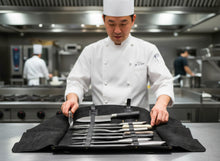 Chef opening black leather knife roll with knives – FashionRacing