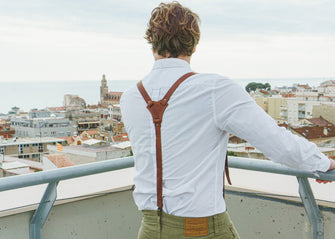 brown leather suspenders with a white shirt, showcasing the fine leather texture