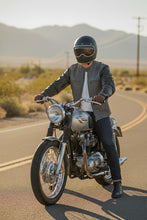 Man riding motorcycle wearing black and grey leather café racer jacket