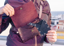 Close-up of a no-sew minimalist leather purse for women in rich burgundy color. Lightweight and durable crossbody bag with adjustable strap.