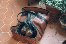 Handcrafted leather log carrier: durable construction and stylish craftsmanship for transporting firewood.