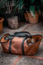  This image features a handmade leather log carrier, meticulously crafted for the purpose of transporting firewood. It offers a practical and stylish solution, ensuring ease of carrying logs with durability in mind.