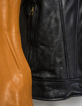 Close-up of a black leather jacket with a brass zipper and an orange leather jacket.