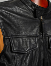 Close-up of a black leather jacket with on a mannequin.