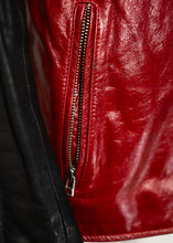 Close-up of a red leather jacket with a zipper