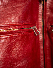 Close-up of a red leather jacket zipper
