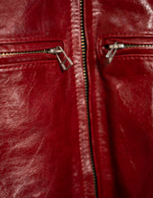 Close-up of a red leather jacket with zipper details