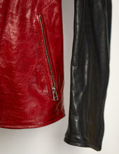 Close-up of a red leather jacket with a zipper and a black leather jacket on a light gray background.