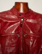 Red leather jacket on a mannequin against a neutral background