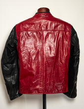 Red and black leather jacket on a mannequin against a white background