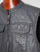 Gray quilted leather vest on a mannequin with a plain background