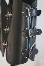 Close-up of metal buckle fastening on leather vest