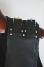 Shoulder buckle detail on men’s leather motorcycle vest