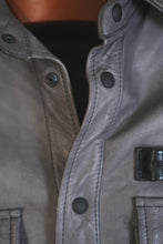 Shoulder and collar detail of gray leather shirt jacket