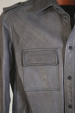 Close-up of snap button detailing on men’s leather shirt jacket