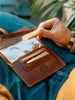Vintage leather tobacco pouch with wrap closure. Handmade travel-friendly rolling accessory for smokers. Compact and durable design, ideal for storing rolling papers, filters, and tobacco on the go.