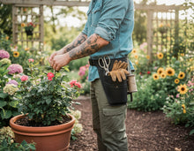 black utility belt with gardening tools including gloves, scissors, and a spool of twine