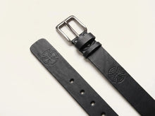 Black genuine leather men's belt with a matte silver metal buckle and embossed logo detail. Durable handcrafted leather belt designed for casual, business, and everyday wear