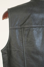 Detailed view of premium black cowhide leather texture and reinforced seams on handmade men’s biker vest.