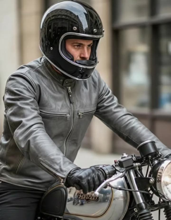 Fashion Racing men’s grey café racer motorcycle leather jacket with built-in protective armor panels, front zip closure, snap-tab collar, zippered chest and side pockets, quilted shoulder detailing, and slim-fit biker style displayed in a product showcase video