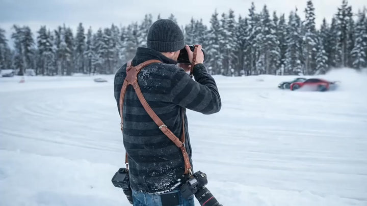 Photographer shotting with Handcrafted Leather Camera Harness by brand Fashion-Racing event porche