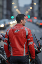 Man wearing red leather motorcycle jacket by Fashion Racing, standing beside a sportbike on a city street at dusk
