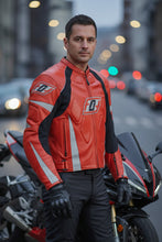 Man in red leather motorcycle jacket by Fashion Racing posing beside motorcycle in the city