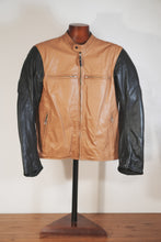 Full front view of tan and black leather motorcycle jacket on mannequin
