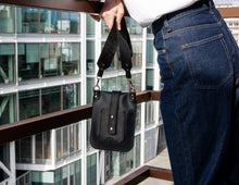 Vertical bag in genuine black leather with wide long strap