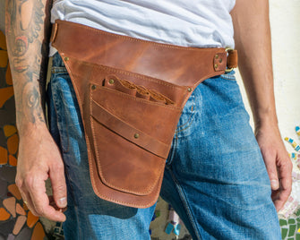 Brown leather tool belt with brass rivets