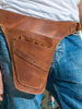 Brown leather tool belt with brass rivets